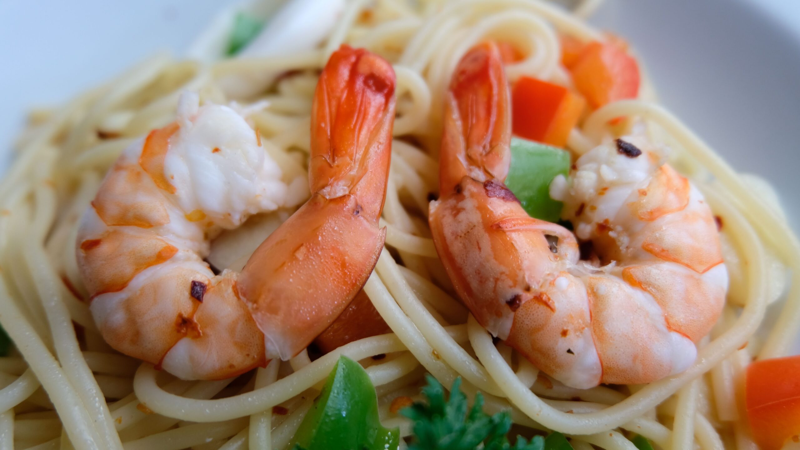 Pan-seared garlic shrimp tossed with tender pasta noodles and fresh herbs