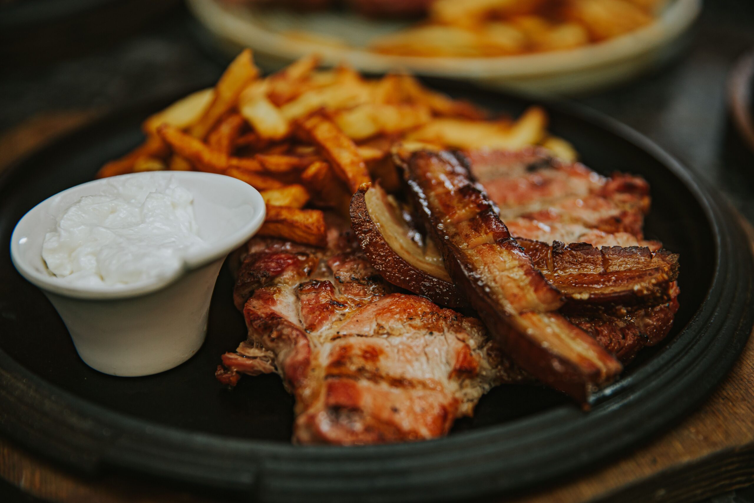 Char-grilled pork chops served with crisp fries and garlic dipping sauce
