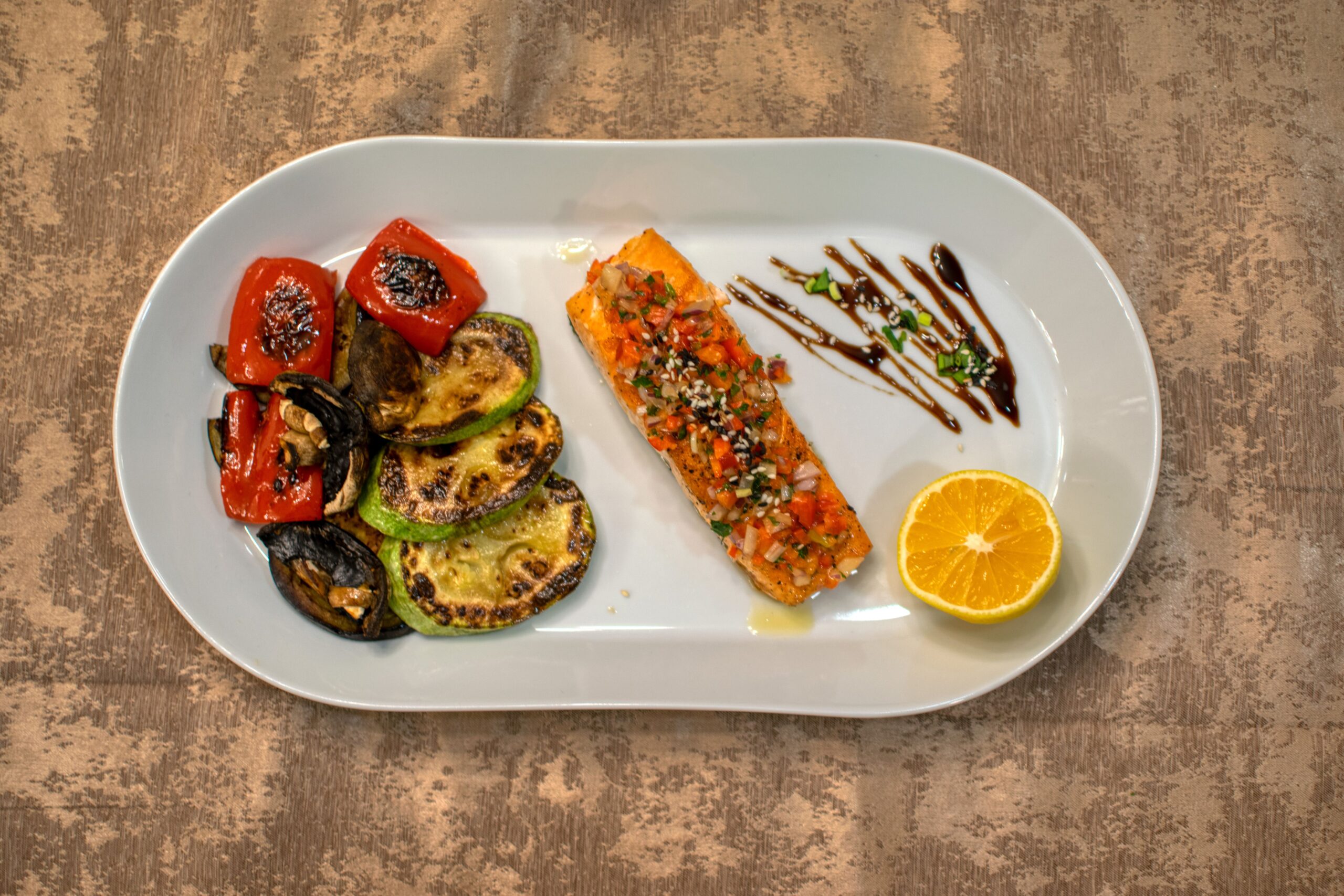 Pan-seared lemon herb salmon steak served with roasted baby potatoes and fresh herbs