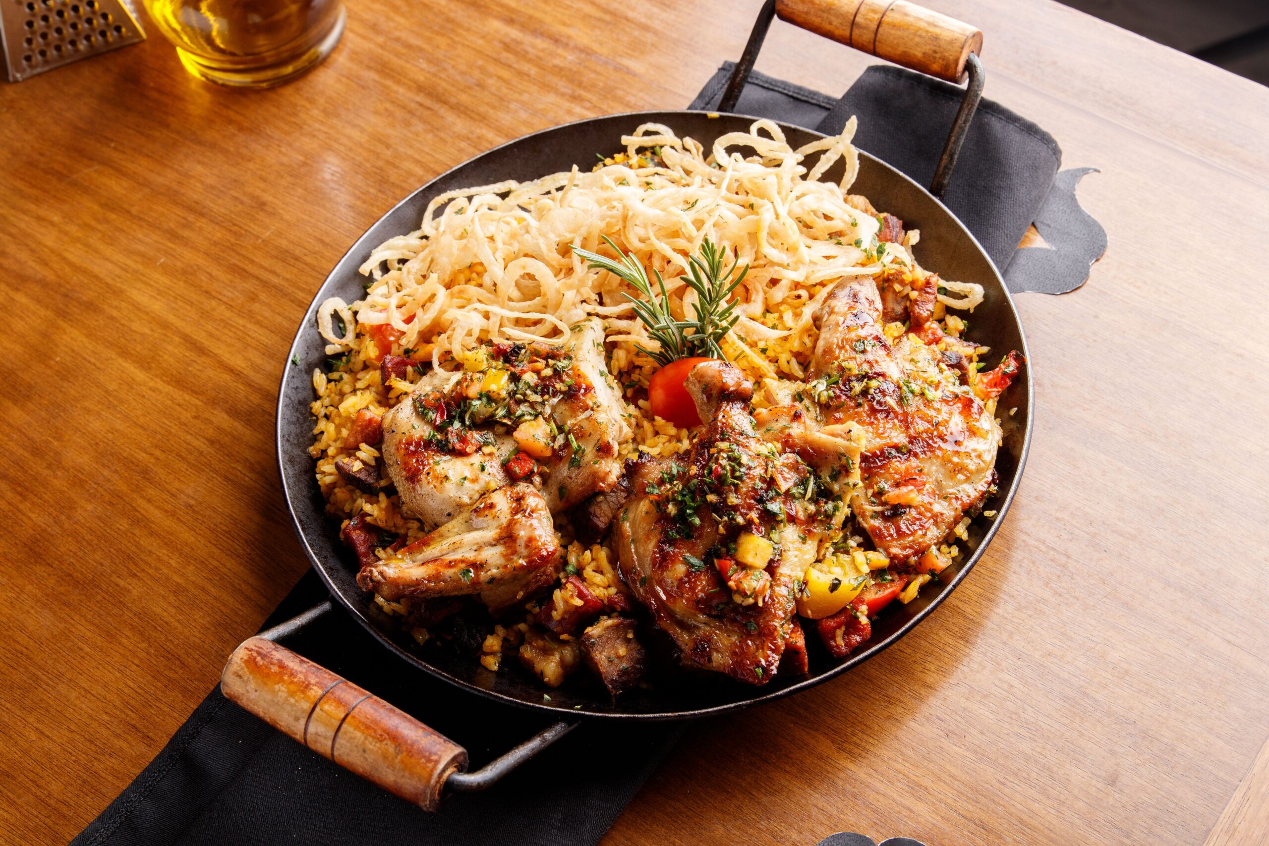 Plated tender chicken dinner served alongside side dishes in a pan dish