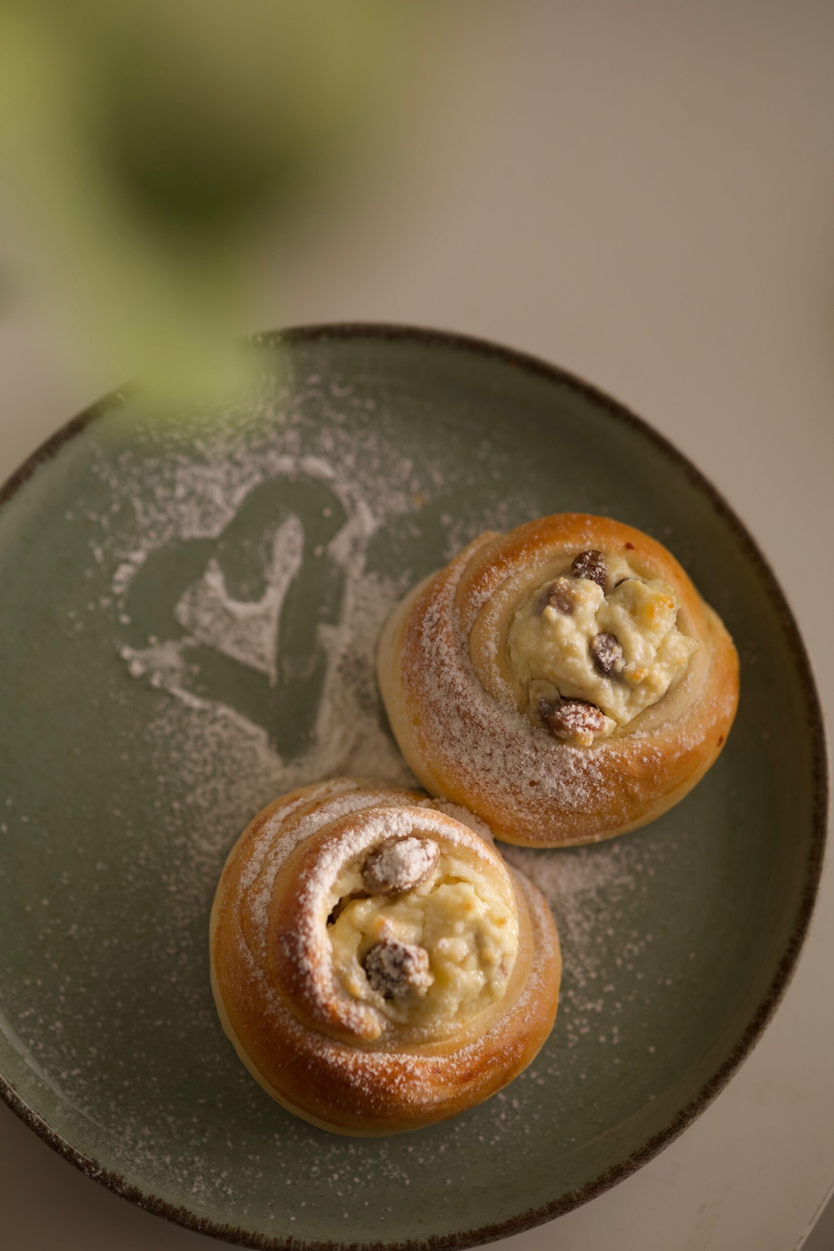 Warm golden brown cinnamon rolls baked together in a ceramic baking dish