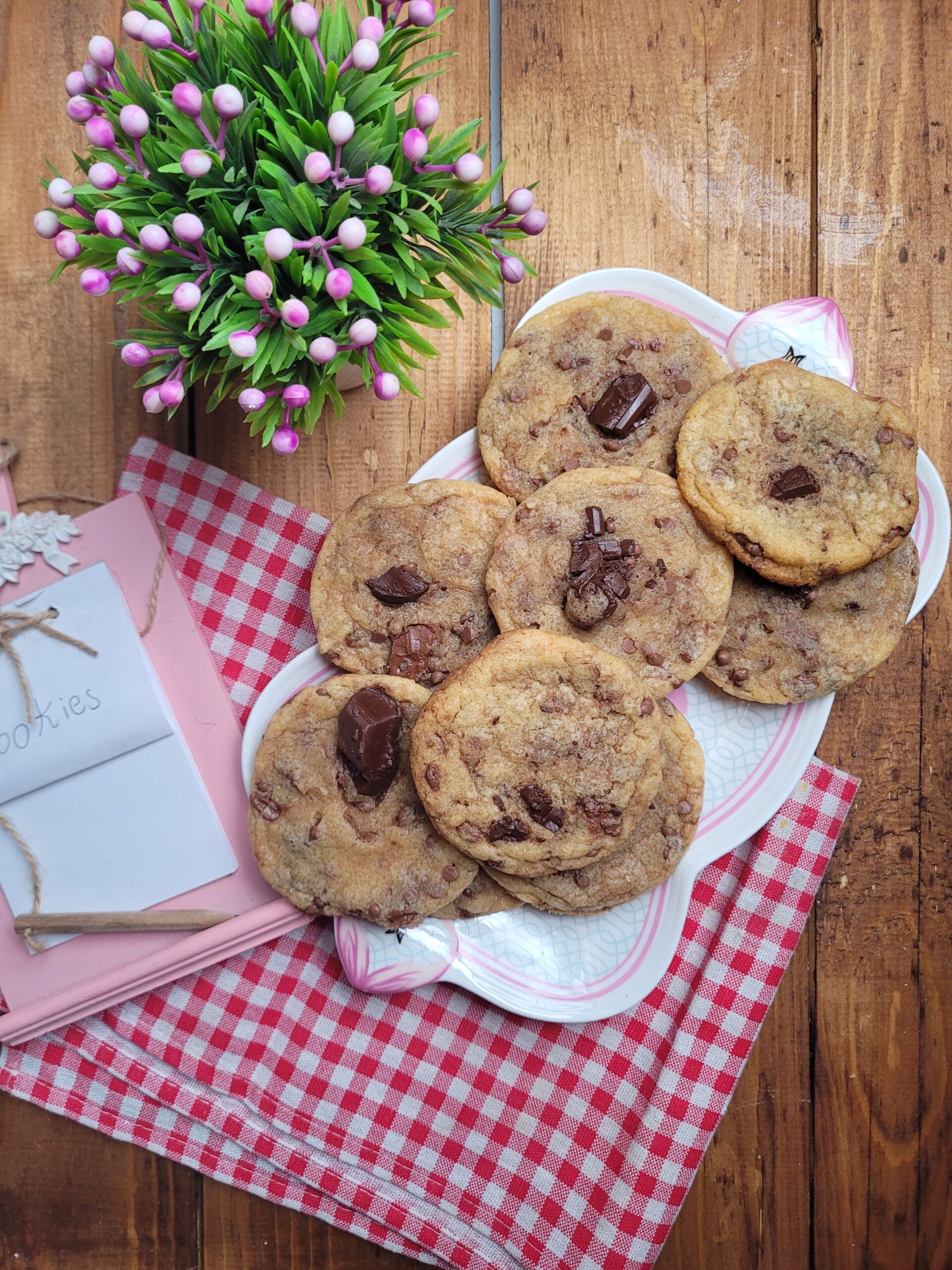 Batch of freshly baked golden brown chocolate chip cookies cooling on a wire rack