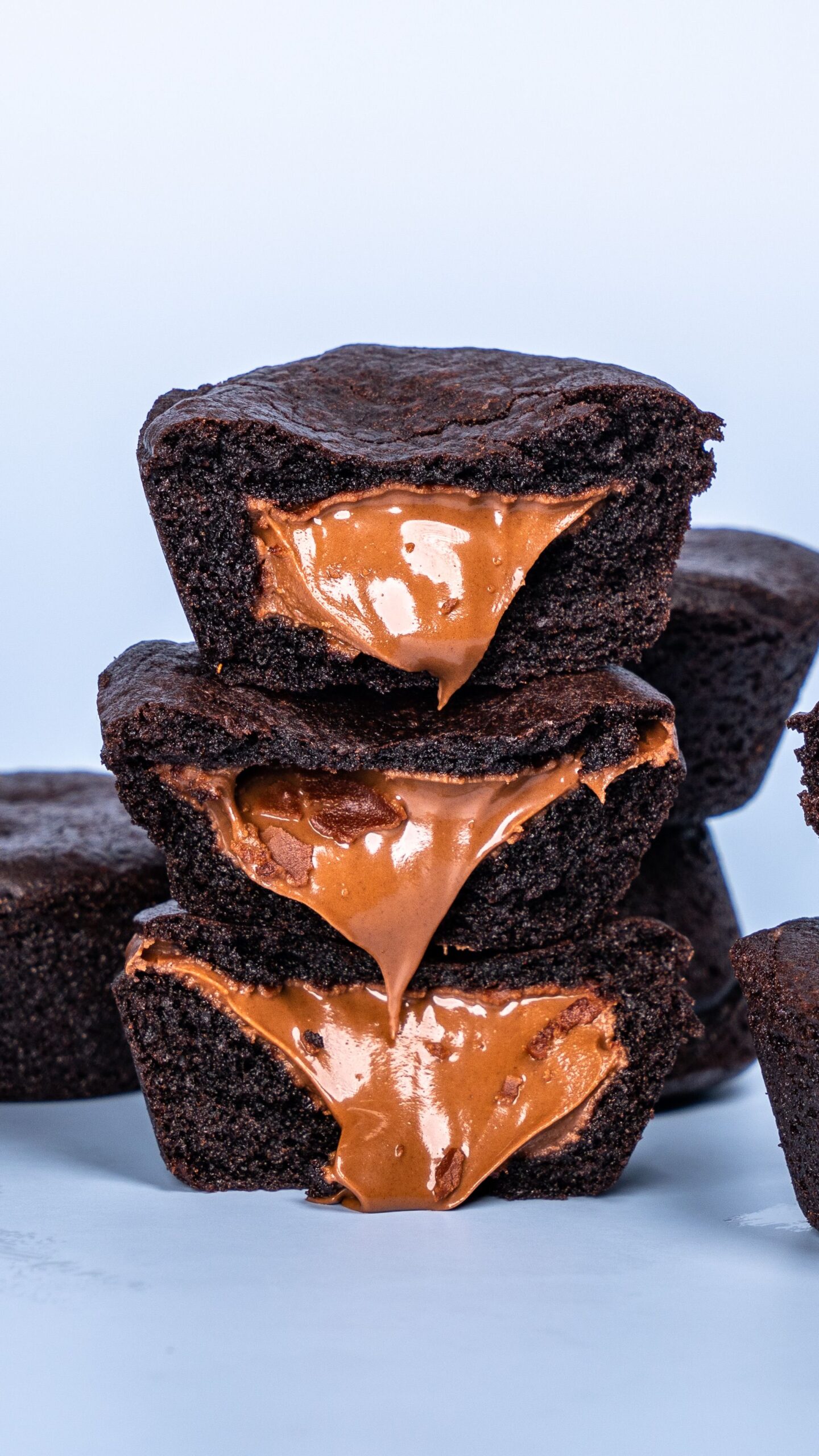 Stack of ultra fudgy dark chocolate brownies cut into squares with crinkly tops
