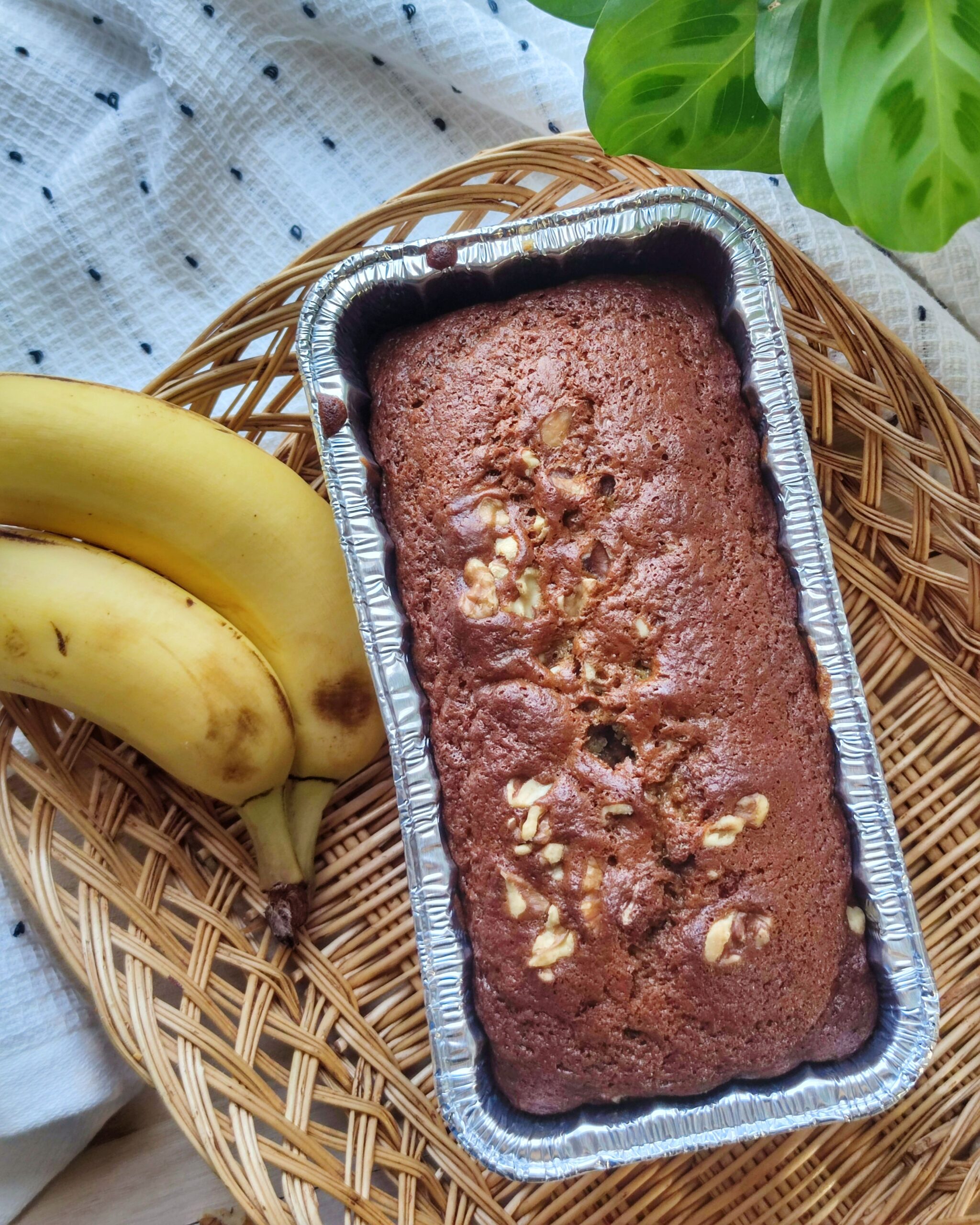 Thick slices of golden moist banana bread resting on a rustic wooden board
