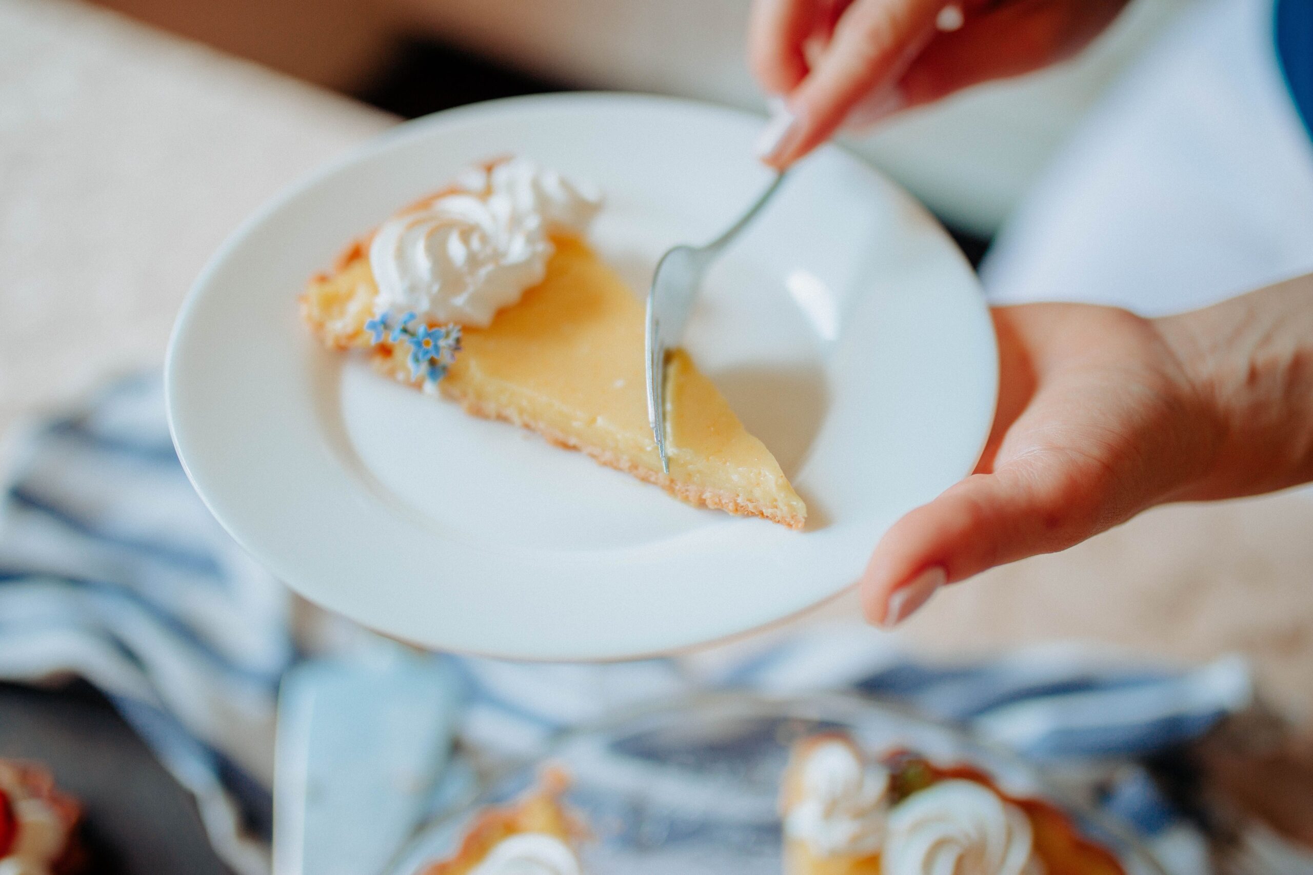 Serving a delicate slice of lemon meringue tart with dessert fork